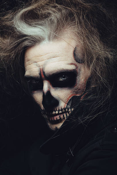 istock Portrait of man with Halloween skull makeup 518878071