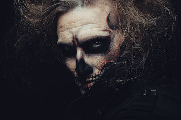 istock Portrait of man with Halloween skull makeup 518878079
