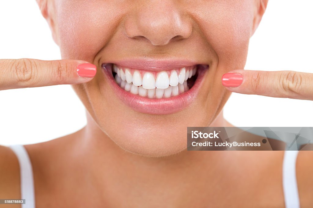 Woman showing her white teeth. Woman showing her perfect straight white teeth. Smiling Stock Photo