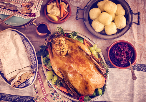 Traditional German holiday goose dinner with dumplings, red cabbage and stollen