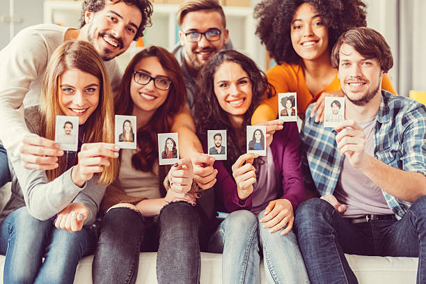istock Group of graduates showing instant self portraits 518883242