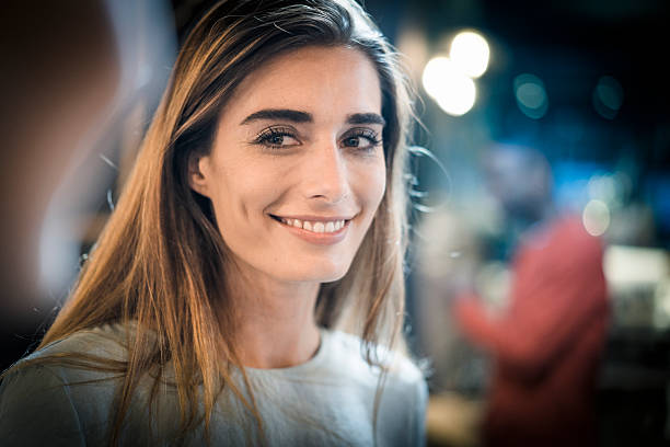 istock Beautiful young woman smiling in restaurant 518883252