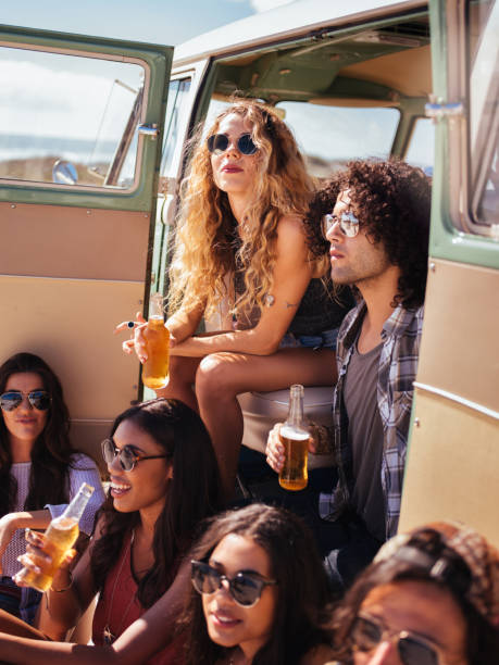 istock Hipster Multi-Ethnic Group Sitting in Back of Van Drinking Beer 518884812