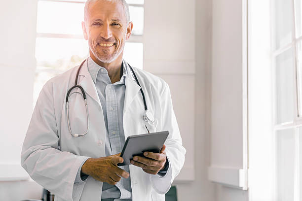 istock Confident doctor holding digital tablet in clinic 518886382