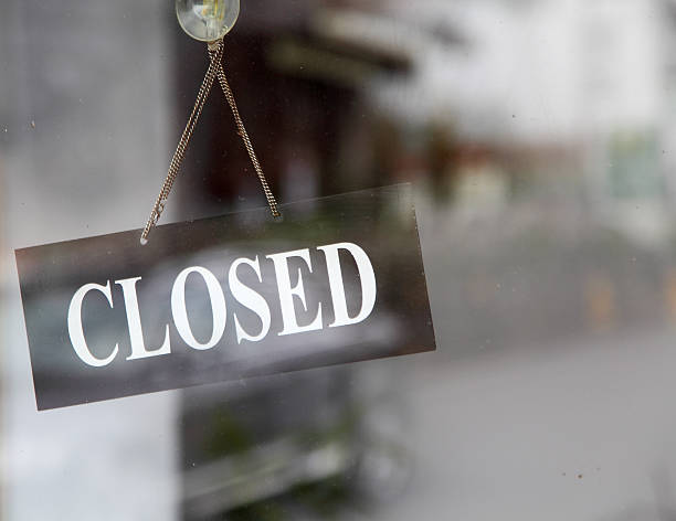 istock closed sign in shop window 518886470