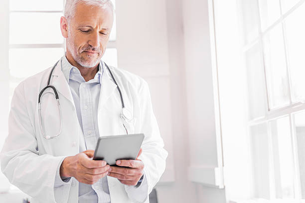 istock Doctor using digital tablet in brightly lit clinic 518886688
