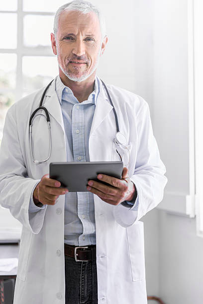 istock Confident doctor holding digital tablet in clinic 518886752