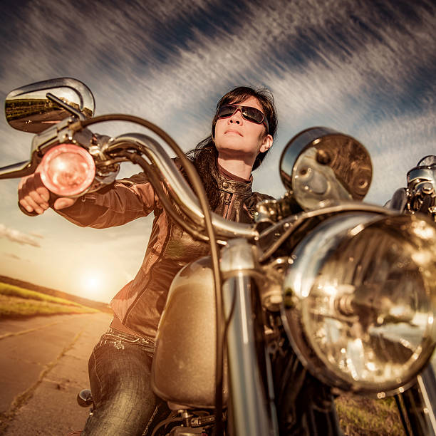 istock Biker girl sitting on motorcycle 518886970