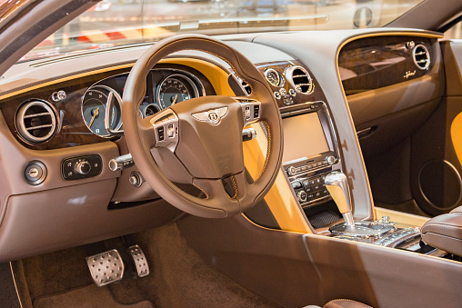 Brussels, Belgium - Januari 12, 2016: Interior on a Bentley Continental GT Speed sports car fitted with dark leather wood and aluminium details and an information display on the dashboard.  The car is on display during the 2016 Brussels Motor Show.
