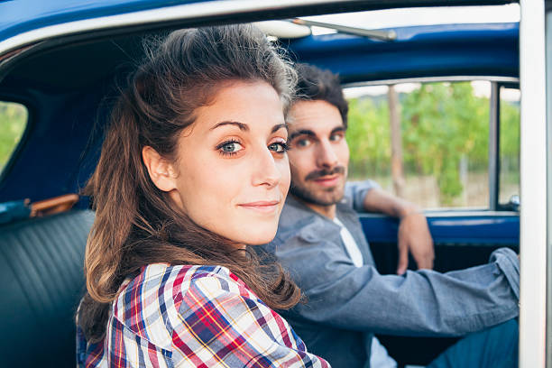 istock Loving couple in an old car 518888632