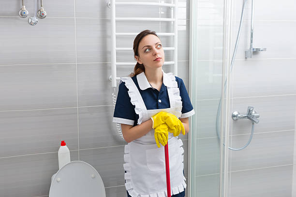 istock Young housekeeper standing daydreaming 518889058