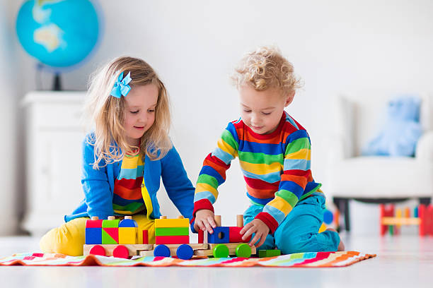 istock Kids playing with wooden toy train 518889368