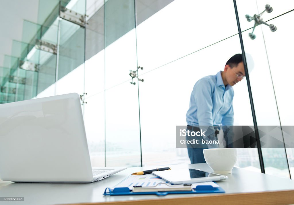 Businessman frustrated Sad businessman with head against wall in the office room. Board Room Stock Photo