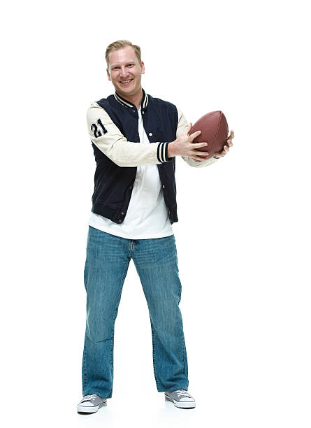 istock Smiling college student holding football 518892127