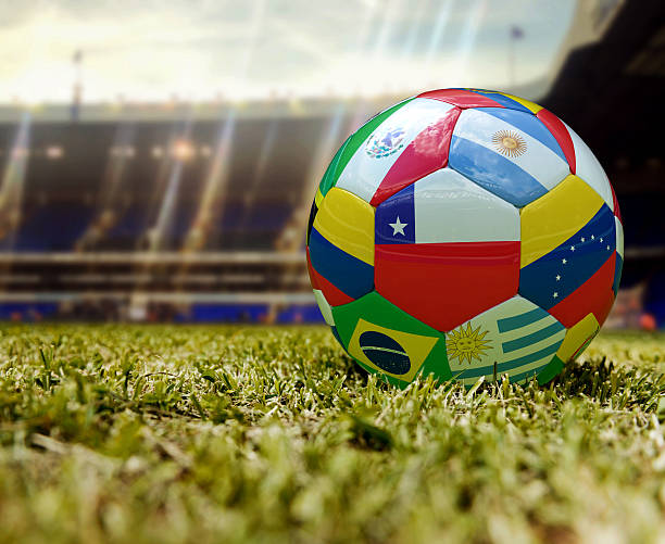 Football in the middle of the stadium with country flags