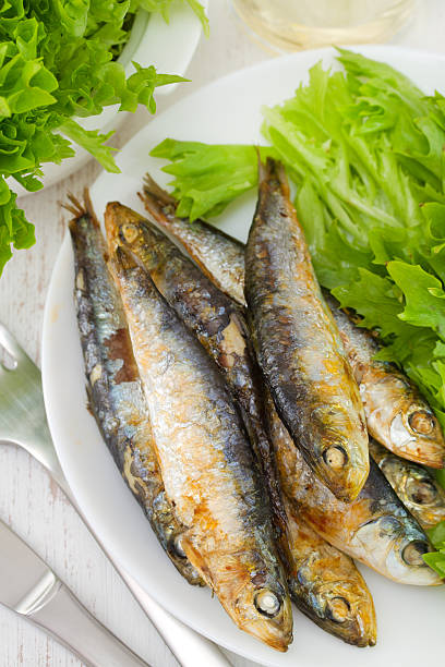 istock fried fish with lettuce on the plate 518893983