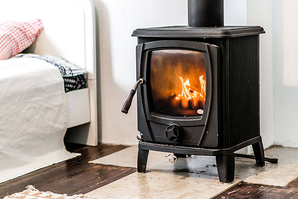 Wood burning stove Wood burning stove in bedroom wood burning stove stock pictures, royalty-free photos & images