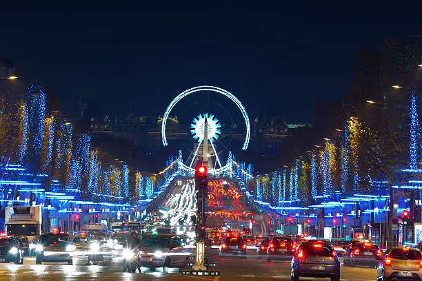 Avenue Champs-Elysees with Christmas illumination and ferris wheel at horizon in Paris, France. Champs-Elysees is one of the most famous streets in the world.