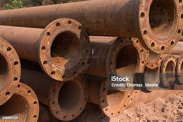 Large Rusted Steel Pipes Lay In A Mine Scrapyard Stock Photo - Download Image Now - Long, Part Of, Scrap Metal