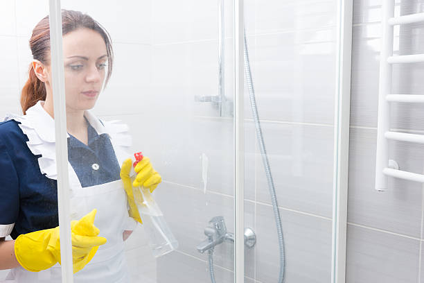 istock Maid or housekeeper cleaning a white bathroom 518897732