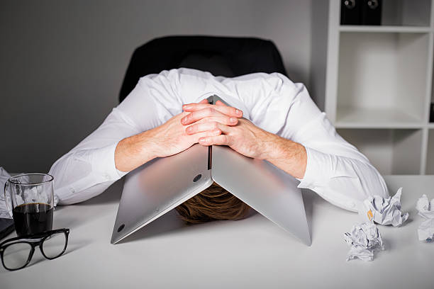 Man hiding under laptop Man hiding under laptop fear stock pictures, royalty-free photos & images