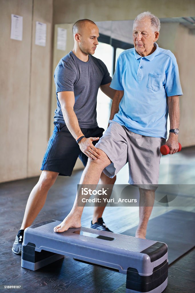 Recovery can be a long road A trainer helping an elderly man with fitness 20-29 Years Stock Photo