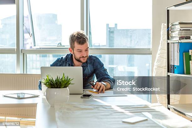 Young Man Working On Laptop Stock Photo - Download Image Now - Adult, Adults Only, Advice