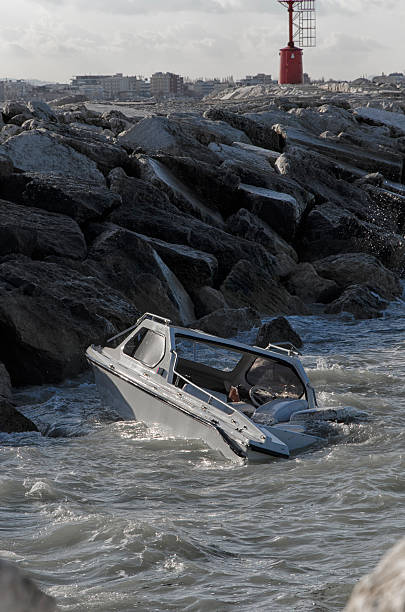 istock Small boat sinking in front of the port 518899434
