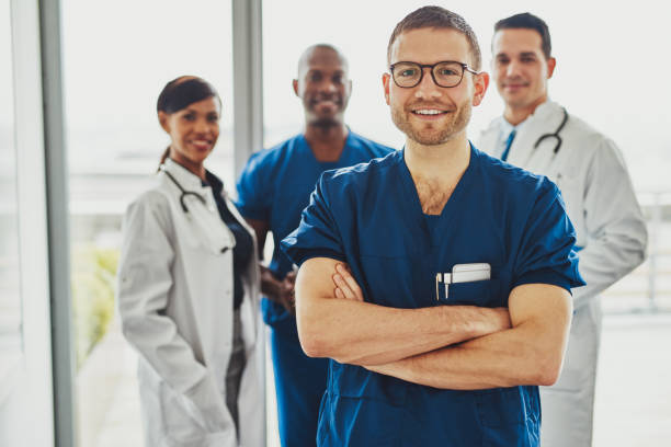 Confident doctor in front of group stock photo