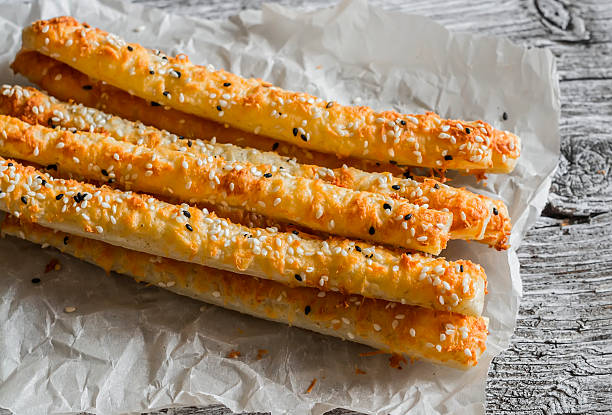 istock Homemade cheese bread sticks on a light wooden background 518900198