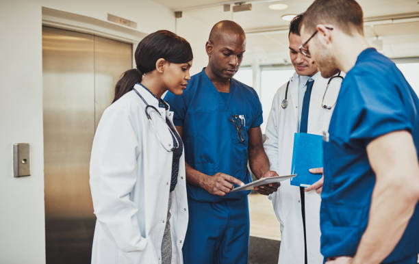 Black surgeon giving instruction to medical team stock photo