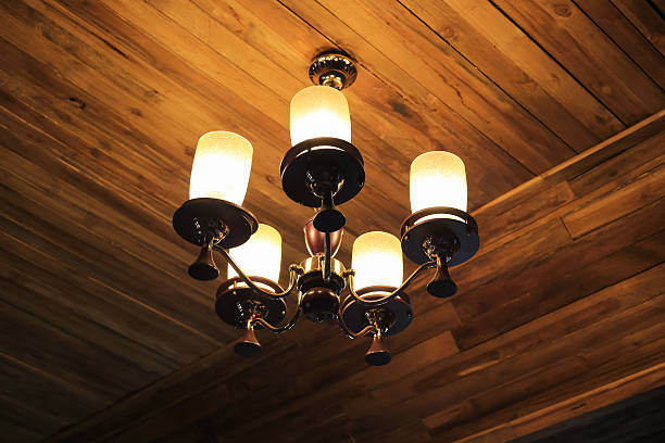 Vintage chandelier hanging on ceiling wooden.