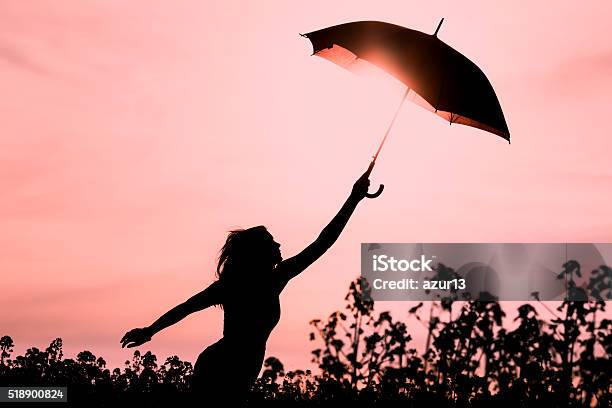 Unplugged Free Silhouette Woman With Umbrella Fly To Future Stock Photo - Download Image Now