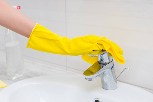 istock Close up of gloved hand cleaning sink 518902796