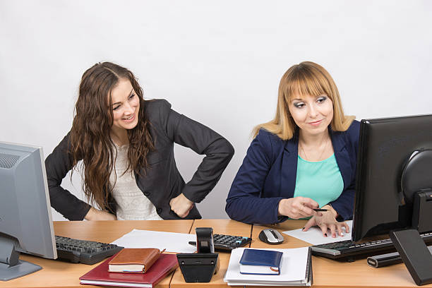 istock Office worker with feigned indignation looking at the colleague sitting 518903776