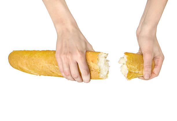 mani rottura una baguette sola su bianco - bread bun broken isolated foto e immagini stock
