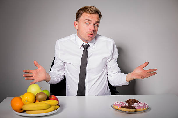 Man choosing between healthy and unhealthy food