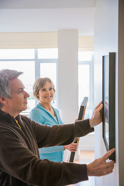 istock Couple hanging art in house 518905978