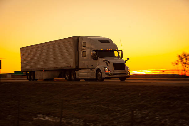 istock Over the road tractor trailer on the highway at sunrise. 518907054