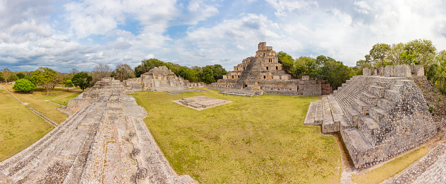 Panorama View of Edzná. Edzná is an archaeological site of the Maya in Edzná Valley in the state of Campeche in the west of the Yucatan Peninsula, Mexico. The developed technology for the disposal of rainwater and the extraordinary facade of the so-called 'palace pyramid' make it one of the most interesting Maya cities. In Edzná located on an area of about 25 km² numerous temples, administrative buildings and palaces. The architecture was influenced by the styles Puuc, Petén and Chenes.