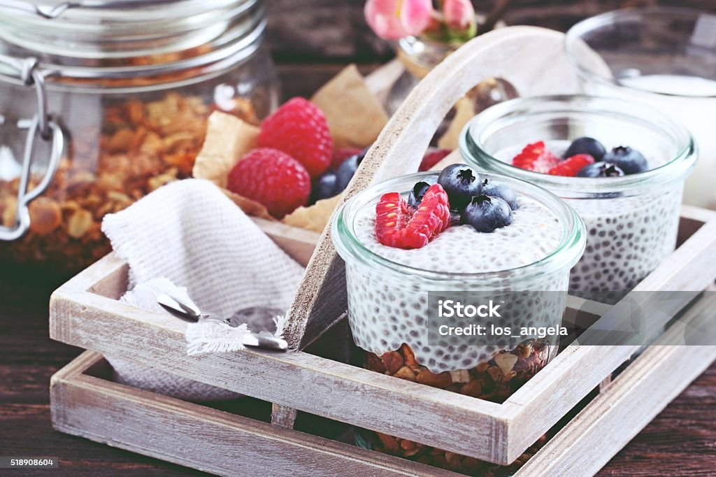 Overnight chia pudding with homemade granola,fresh berries and honey. Superfoods concept : overnight chia pudding with homemade granola,fresh berries and honey. Healthy eating. Selective focus.  Antioxidant Stock Photo