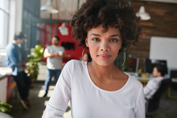 istock Confident young female designer standing in her office 518908626
