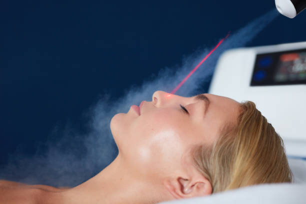 istock Localized cryotherapy on woman face 518909344