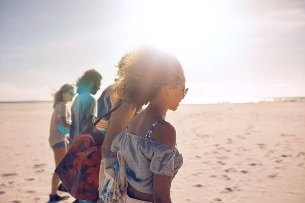 istock Friends walking along the beach on a sunny day 518909860