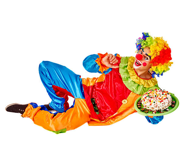 istock Happy birthday clown holding cake 518910392