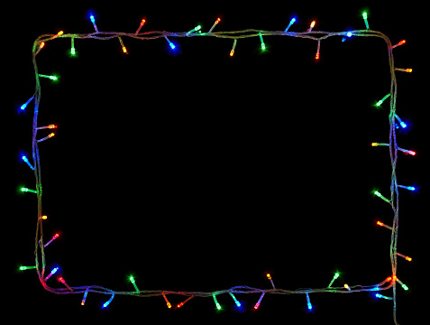 Christmas lights frame on black background with copy space.Decorative garland