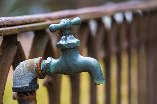 An old water faucet outside an ancient cemetary in southeastern Massachusetts.
