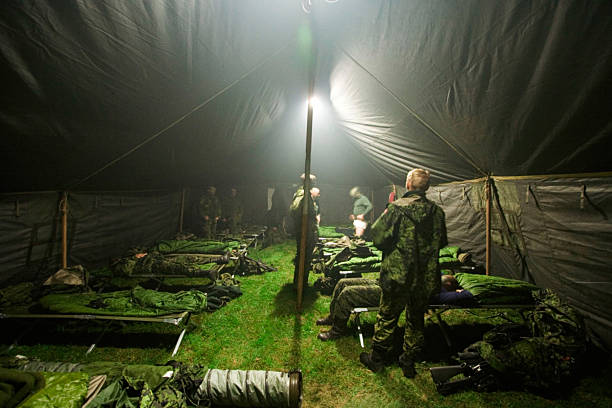 Bunking down for the night Soldiers getting ready to bunk down inside of their large tent - This is the real thing from KFOR, Kosovo 1999. This image is part of our historic collection. The digital cameras available back then where very bad, so expect exceptionally bad image quality barracks stock pictures, royalty-free photos & images