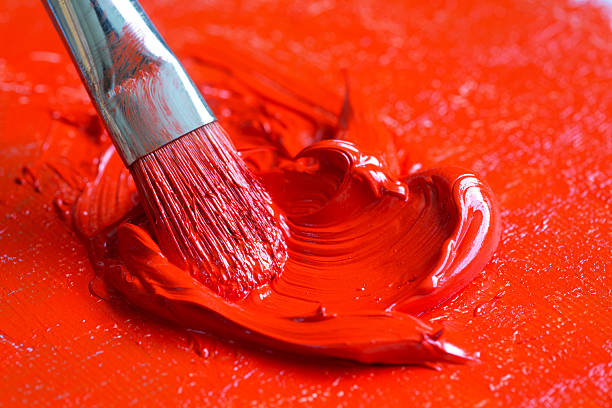 istock Paintbrush with red oil paint on a canvas 518912465
