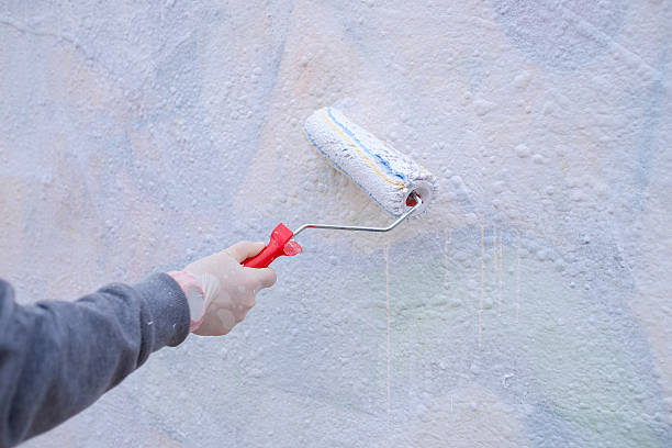 istock Hand Holding a Paint Roller and  Painting 518913134